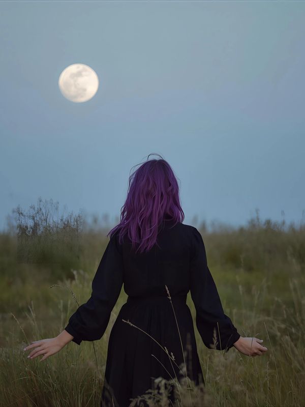 a lady wearing a black dress with long sleeves, log purple hair walkng in a meadow with a full moon