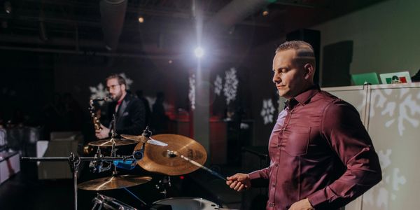 Percussionist and Saxophonist playing along to a DJ, with intelligent lighting