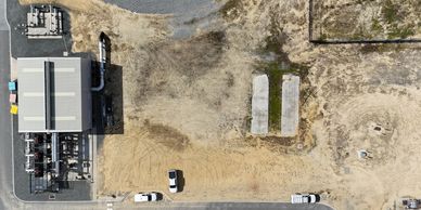 Aerial view of an industrial site with vehicles and equipment.
