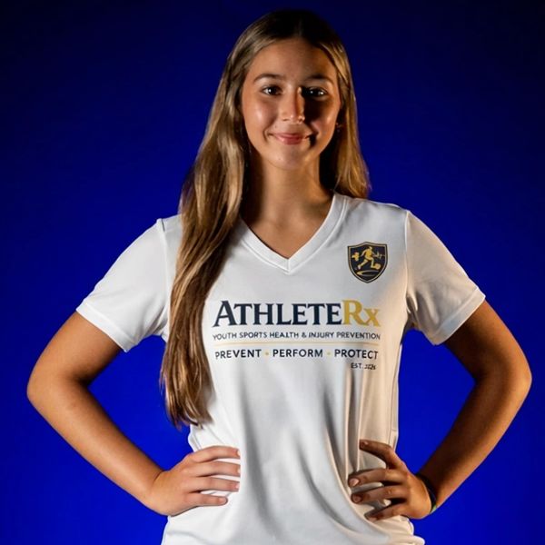Young female athlete in white AthleteRx shirt posing confidently against blue background.