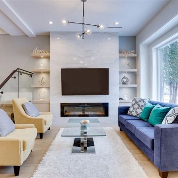 Modern living room with cozy seating and a sleek fireplace.