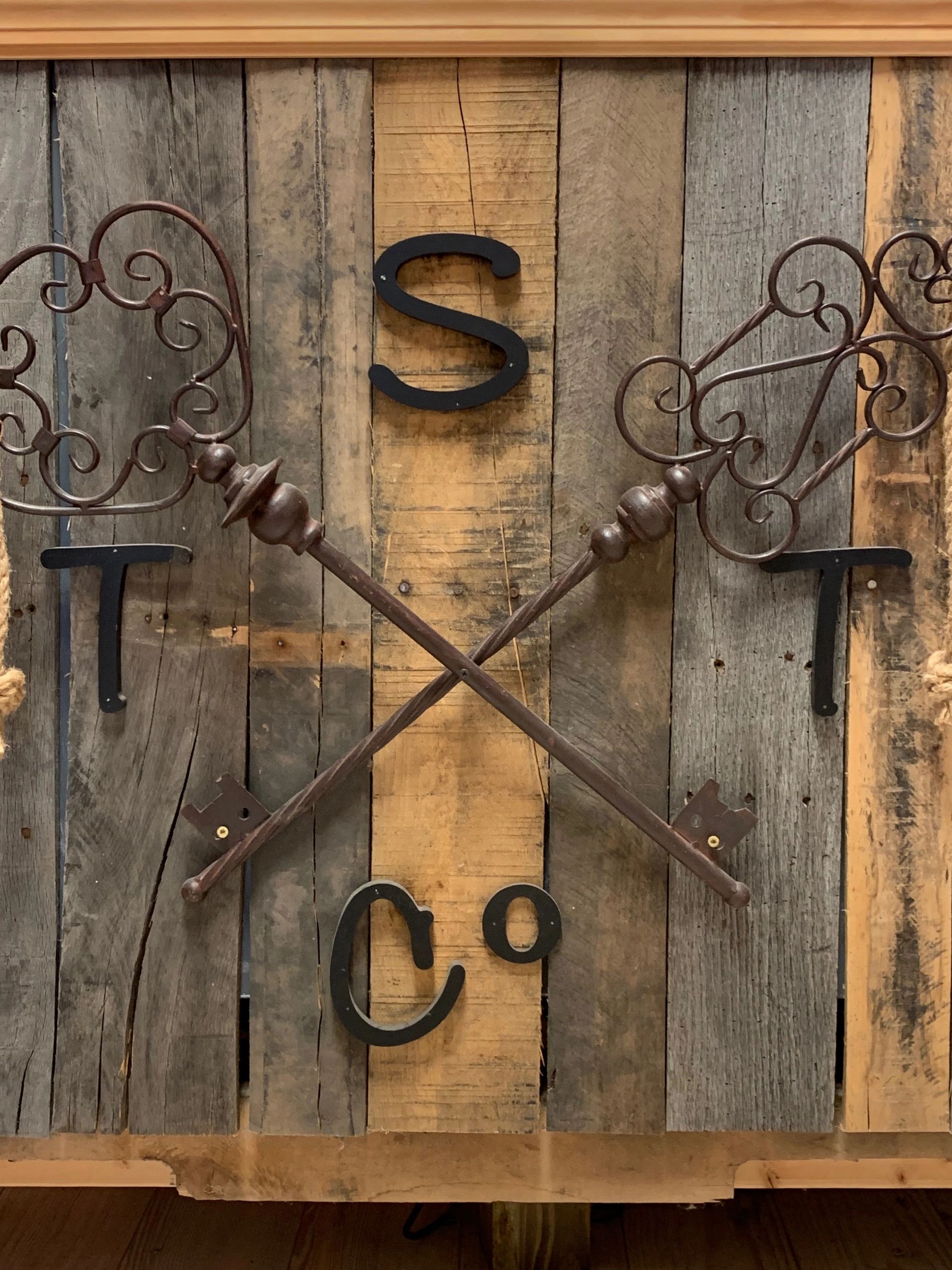 Decorative rustic keys crossed on a wooden plank background with letters.