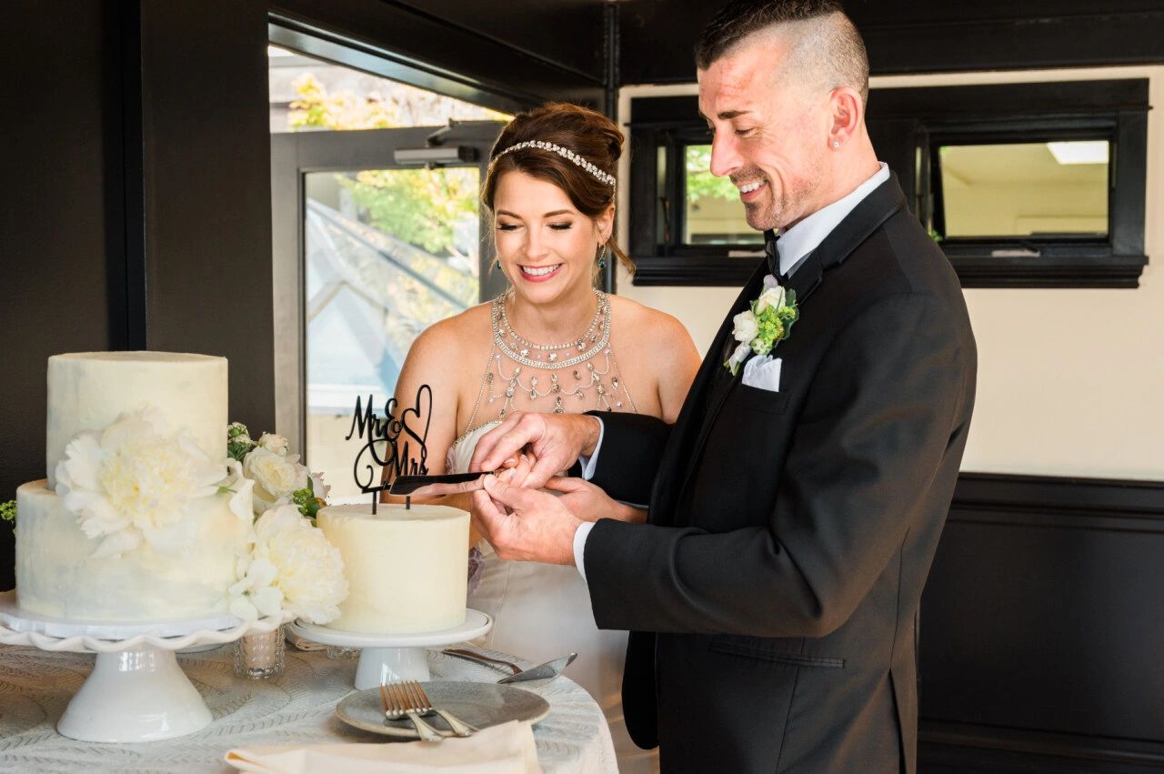 Bride and groom cutting their cake. 