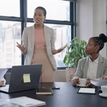 Businesswoman presenting ideas during a meeting in a modern office.