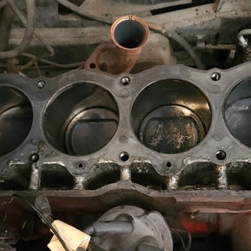 Close-up of an engine block with visible pistons and cylinders.