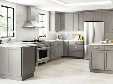 Sleek gray cabinets with clean lines, soft finish, and ample storage create a modern, elegant kitche