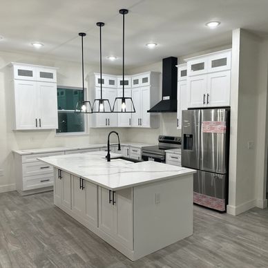 "White cabinets, quartz countertops, and black accents create a sleek, modern, and timeless kitchen."