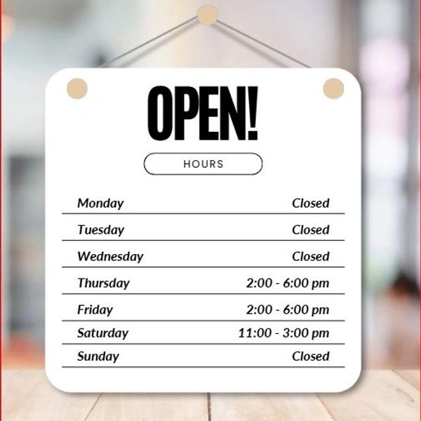 Sign showing business open hours from Thursday to Saturday, closed other days.