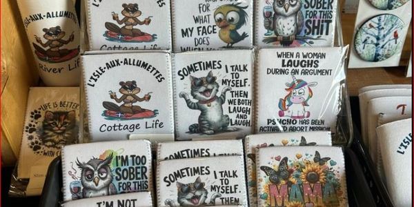 A display of humorous and quirky printed drink holders with various cartoon characters and sayings.