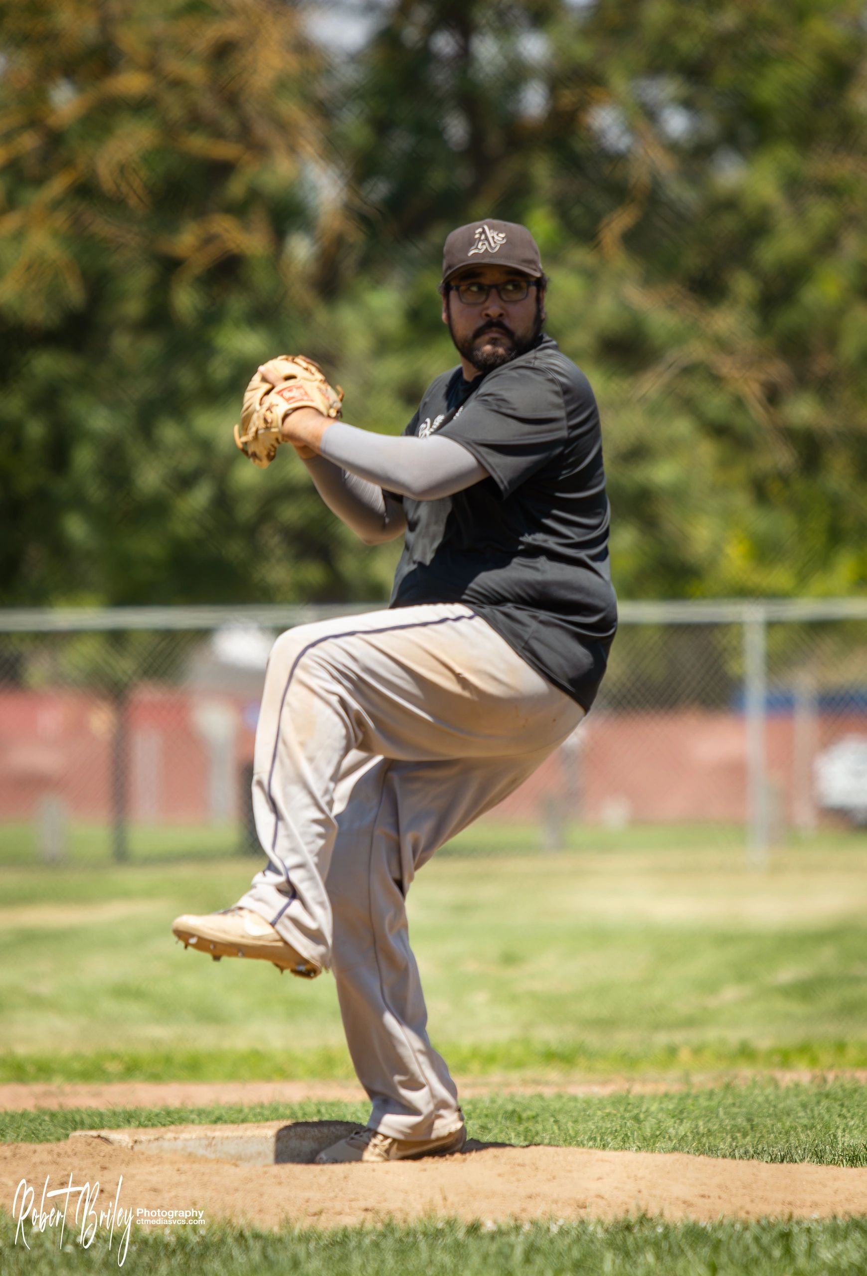Baseball pitcher preparing to throw a pitch on the field.