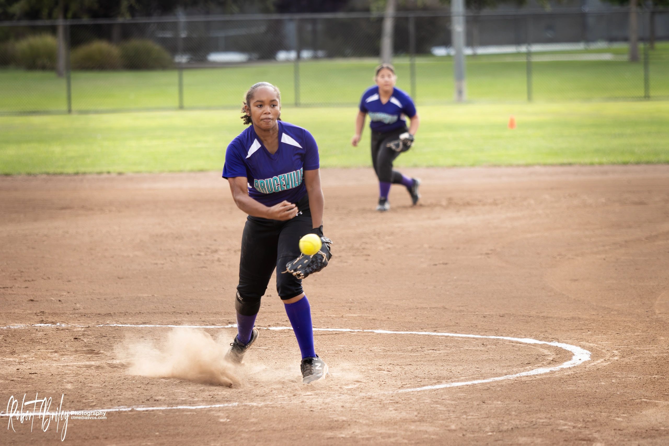 Female softball pitcher releasing the ball.