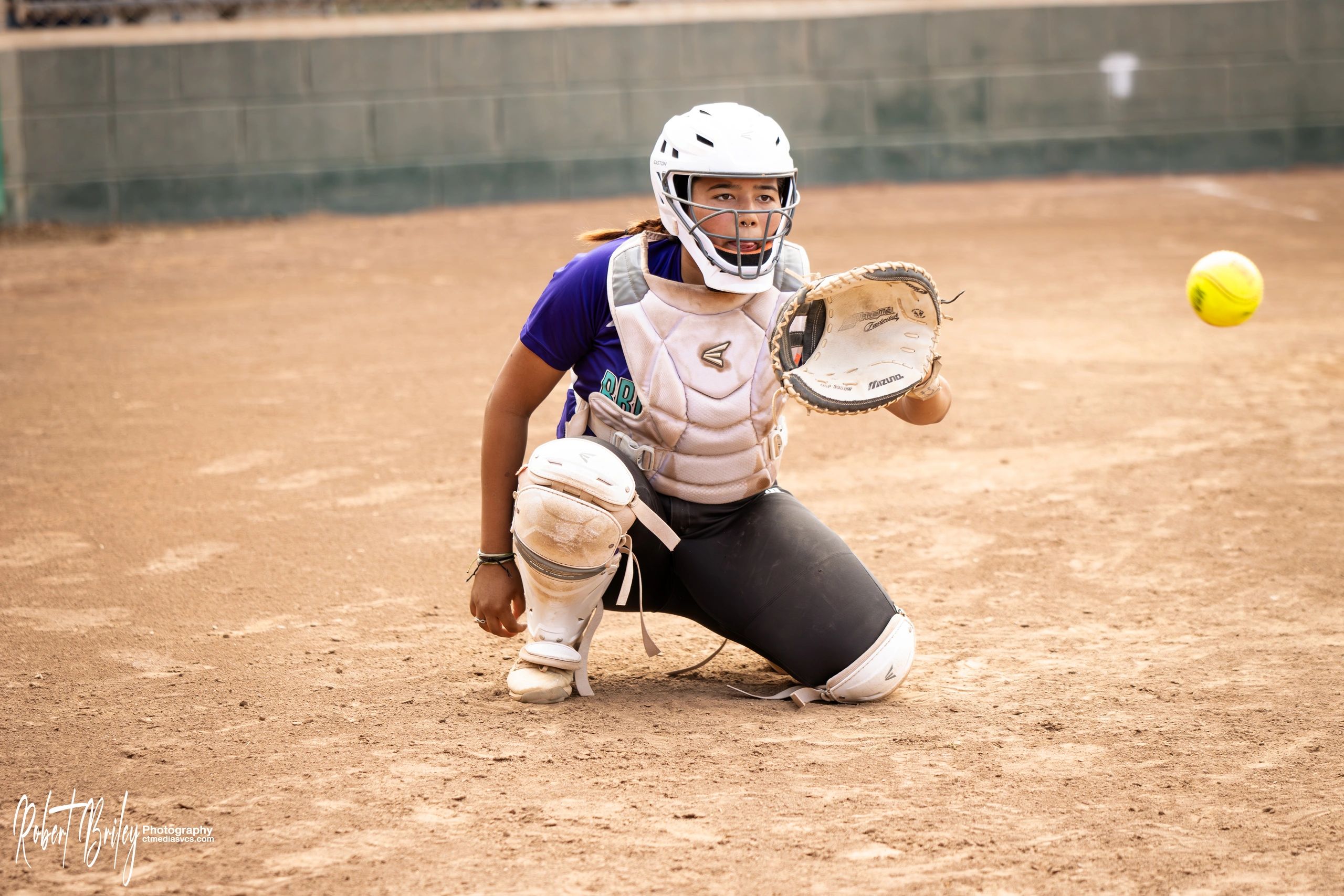 Softball catcher preparing to catch the ball.