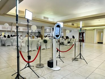 Photo booth setup at an event with seated guests.