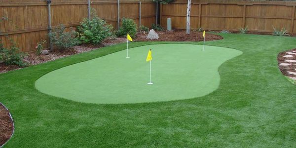Custom backyard putting green installation for residential and commercial properties.