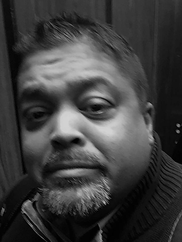 Close-up black and white photo of a man's face.
