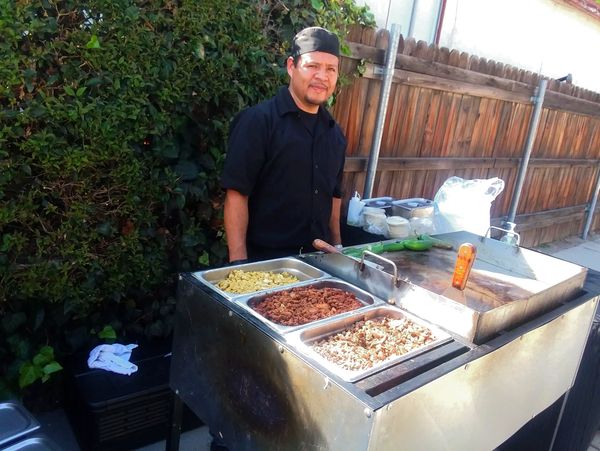 Taco cook preparing food for a taco catering service.