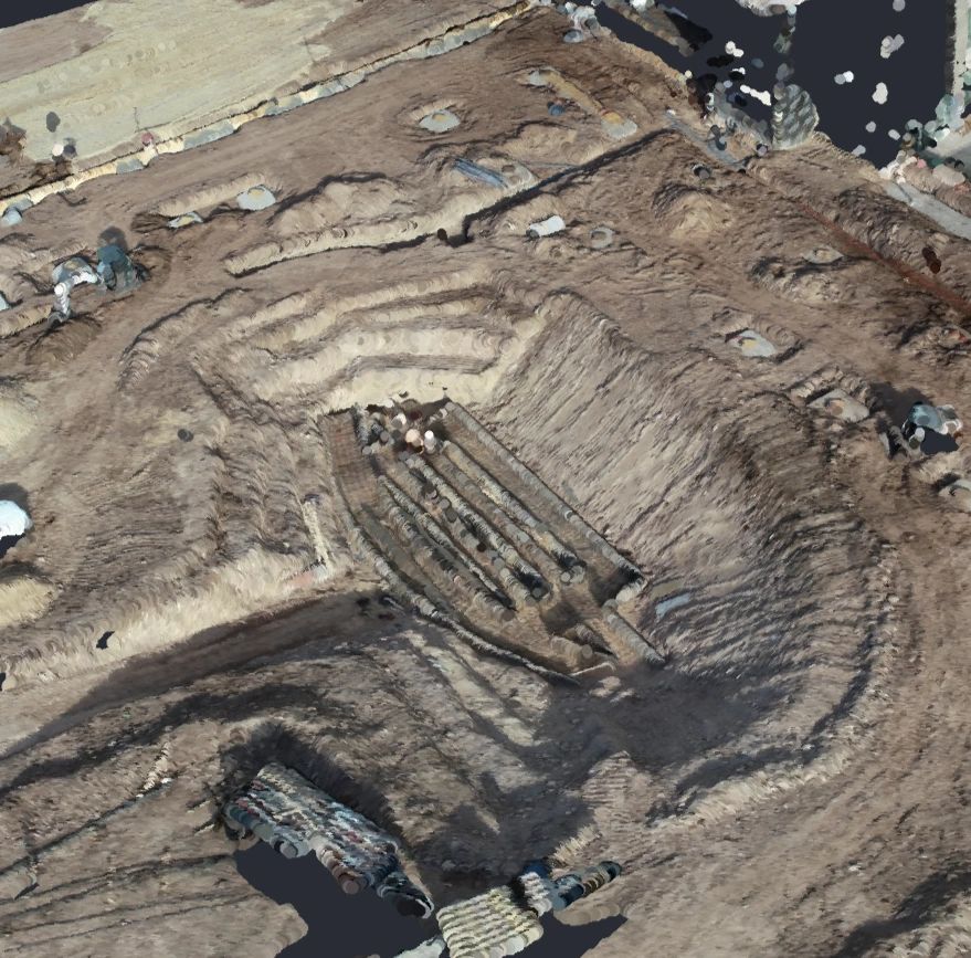Aerial view of an archaeological excavation site with trenches and unearthed structures.