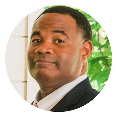 Man in a suit with a subtle smile.