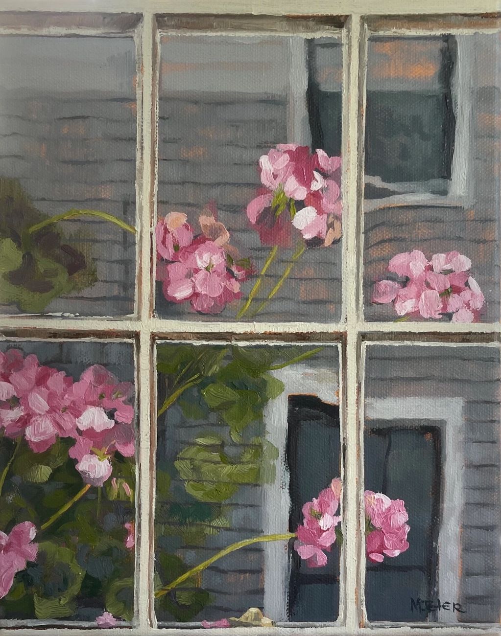 Pink flowers seen through a window with a gray brick wall background.