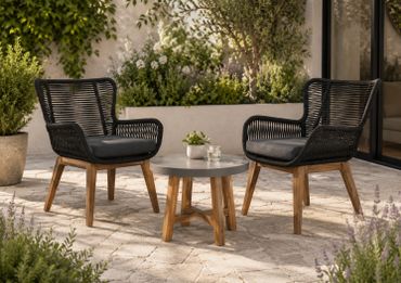Outdoor seating with two black wicker chairs and a small round table.