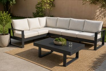 Modern outdoor sectional sofa with beige cushions and black frame on a natural fiber rug.
