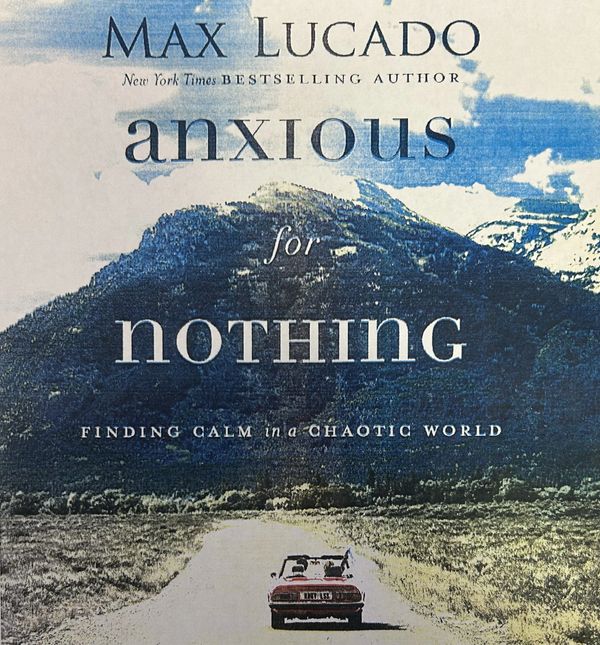 Book cover of Max Lucado's 'Anxious for Nothing' with a scenic mountain and car image.
