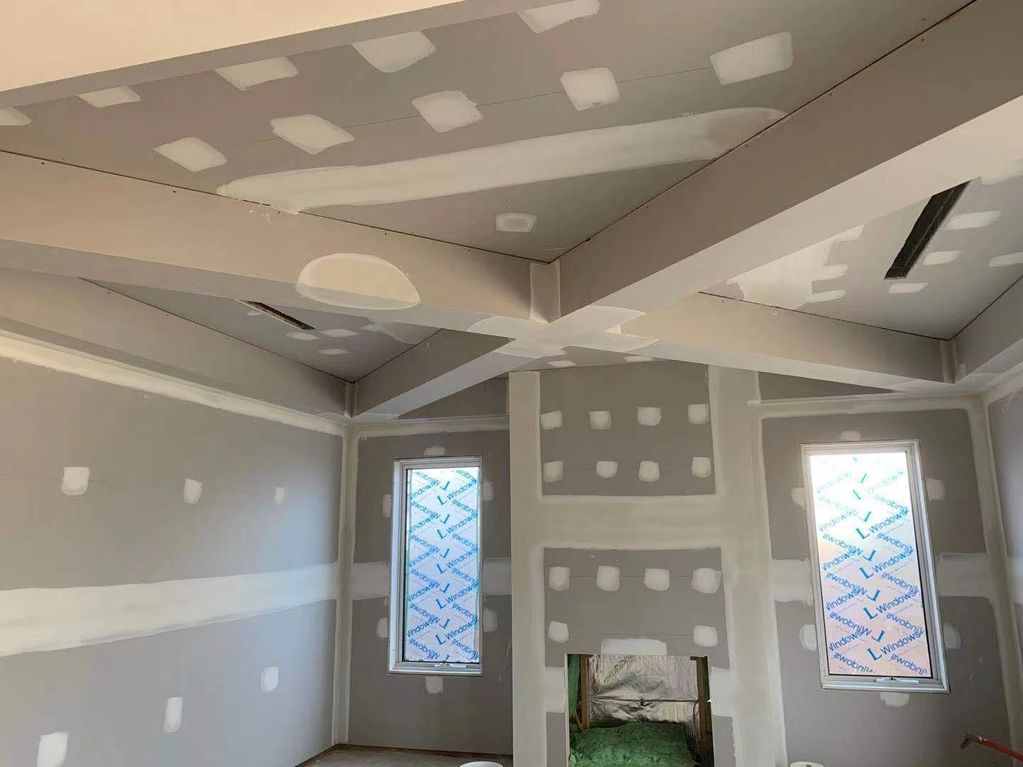 Working intently on a PUP wooden piece in the room.