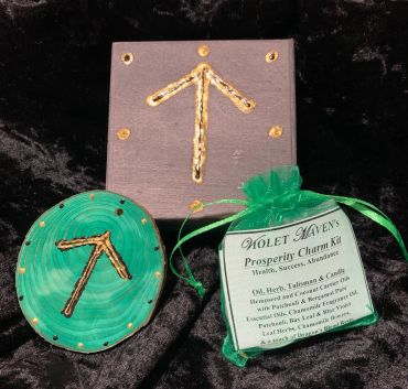 Prosperity charm kit with rune symbol on wood.