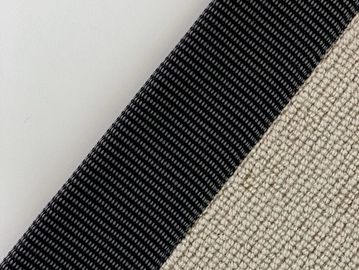 Close-up of a textured fabric with black and beige sections.