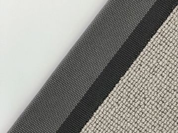 Close-up of textured fabric with contrasting gray and beige sections.