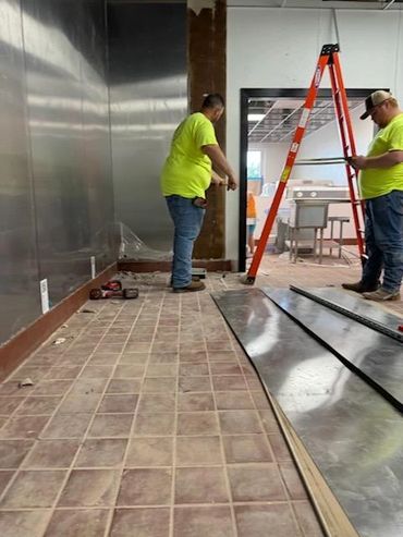 Our team prepping the walls for a kitchen hood installation