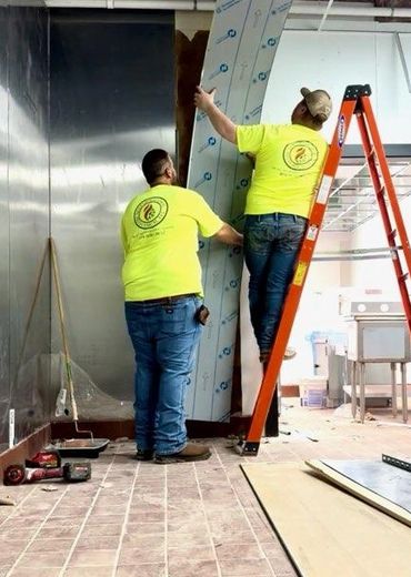 our team prepping the walls getting ready to install a hood