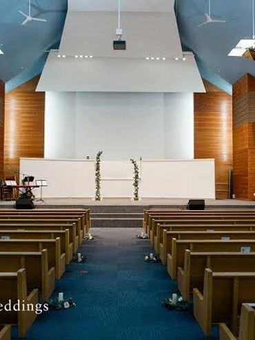 Modern church interior decorated for a wedding ceremony.