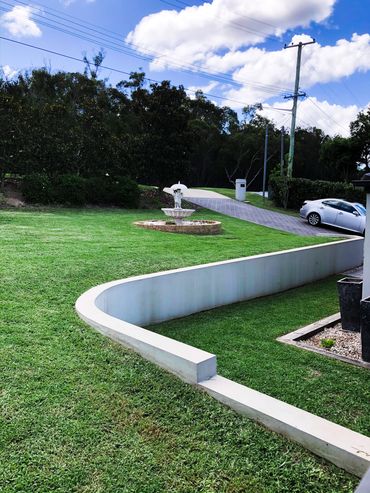 Water feature and retaining fall complementing our fresh lawn and gardening.
