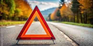 Red warning triangle on an empty road.