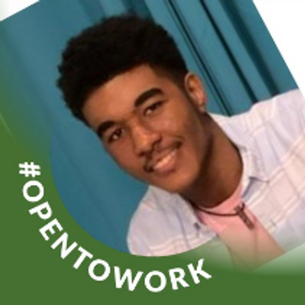 Young man smiling with #OPENTOWORK banner.
