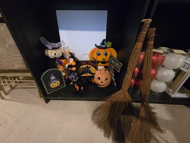 Halloween decorations with pumpkins and brooms.