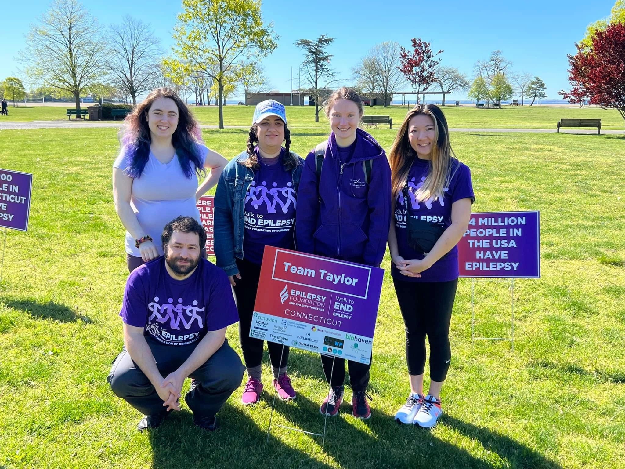 Group of people at a walk to end epilepsy event in a sunny park.