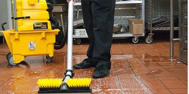 a person cleaning a floor in a restaurant