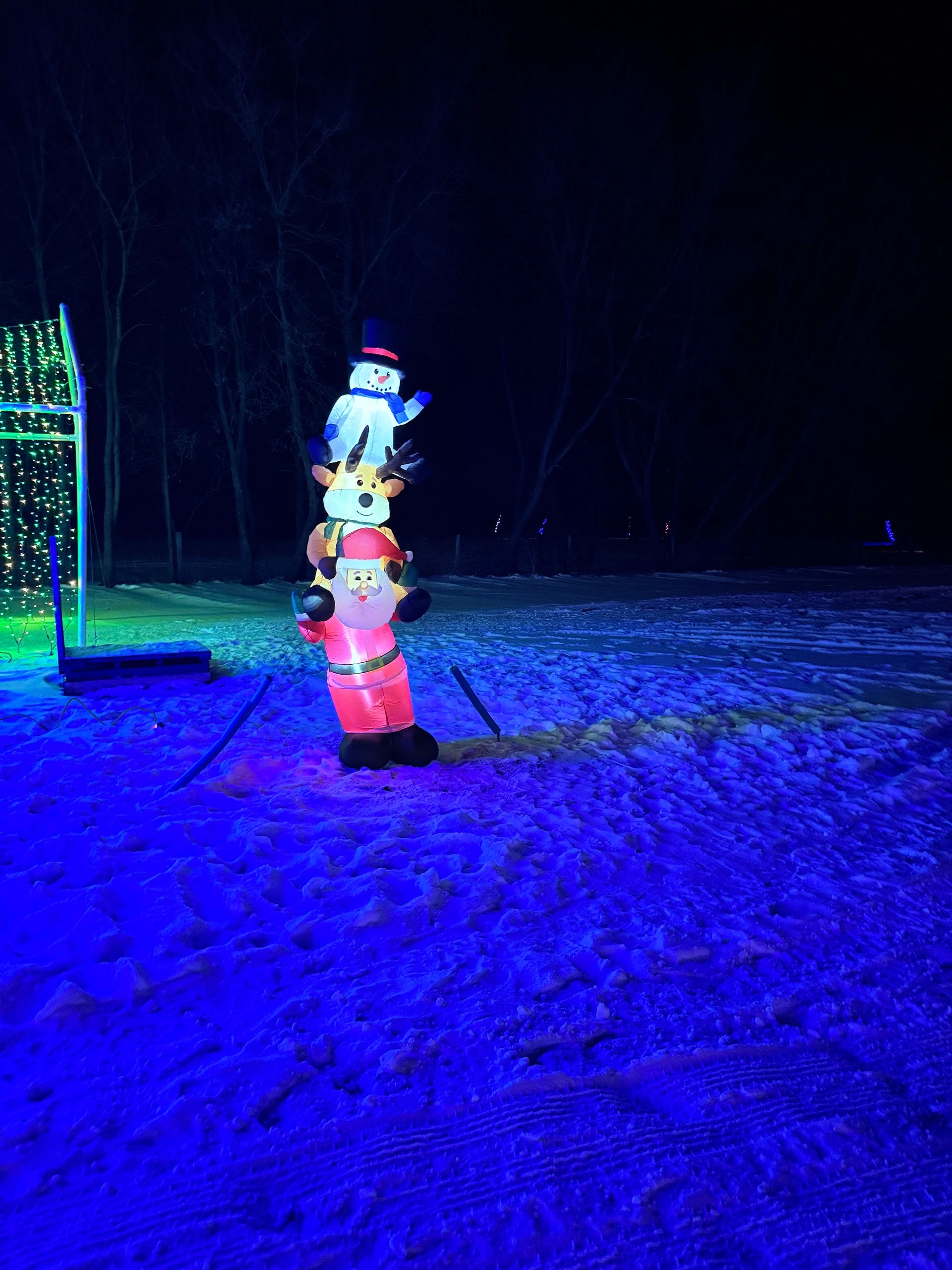 Stacked Santa, reindeer and snowman inflatable Christmas display along the light show