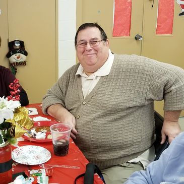 Eating lunch, senior gentleman, beige sweater, cane, dining center, senior