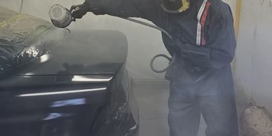 Spray painting a car in a spraybooth