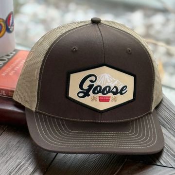 Brown and beige Goose branded trucker hat with mesh back.