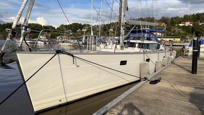 A white sailboat docked at a marina on a sunny day.
