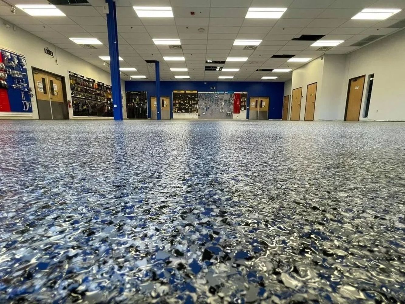Stack of books next to pencils in a holder and a camera.