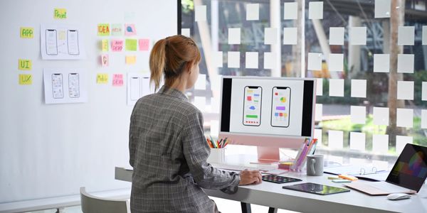 the woman at a computer designing a learning experience.