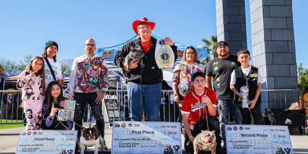 Group with dogs celebrates winning dog show.