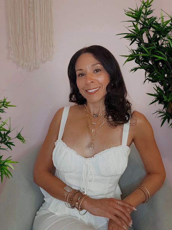 A scenic landscape featuring mountains, a lake, and a clear blue sky.