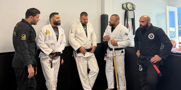 A group of black belts talking and smiling