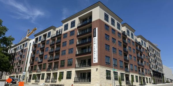 Modern apartment building with a leasing sign.